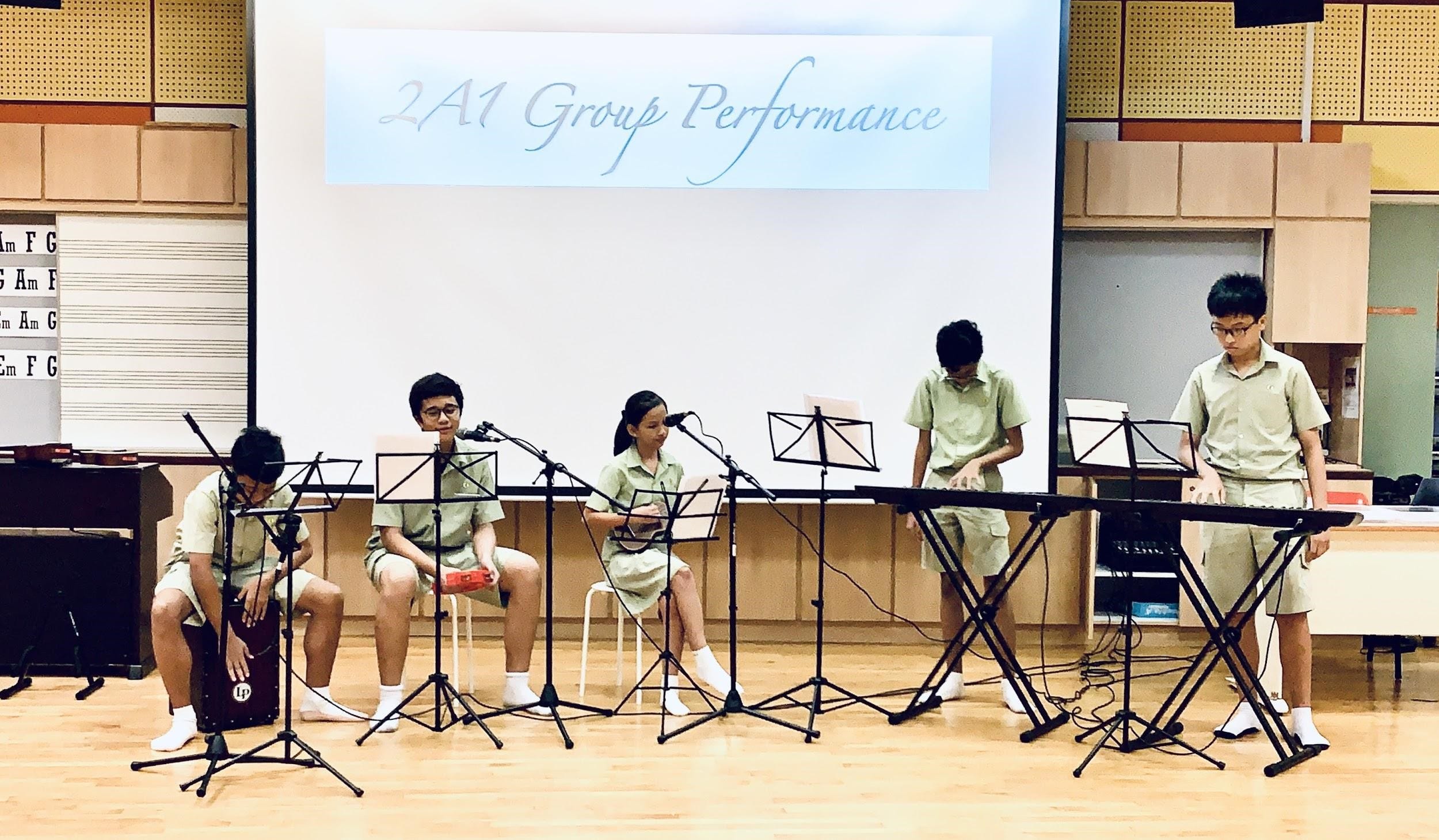 Students collaborate with their peers to perform as a pop band